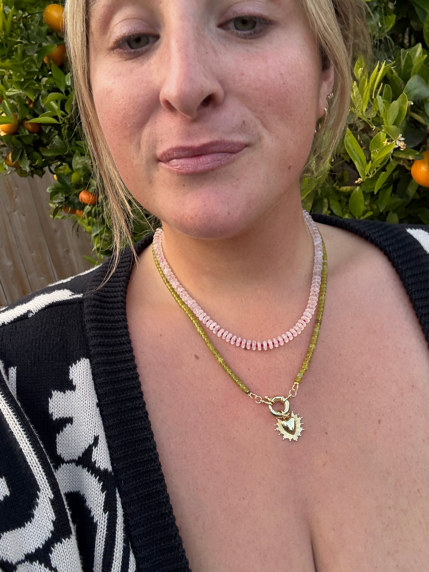 Green and metallic necklace with heart burst charm