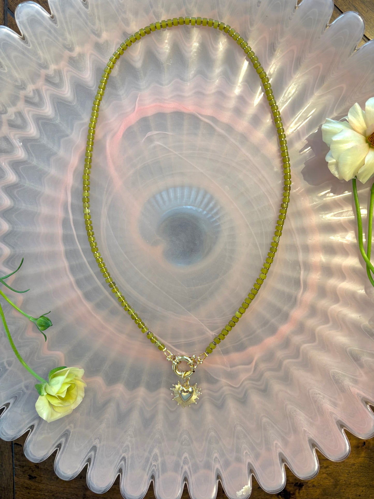 Green and metallic necklace with heart burst charm